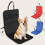 A dog sitting on a dog car seat protective mat attached to the back of a rear seat, with straps around the headrest and several colors visible.
