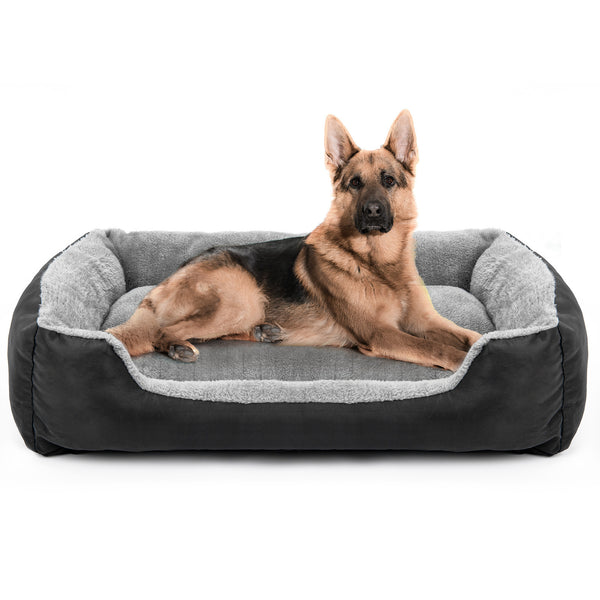 Chien de grande taille allongé confortablement dans un panier gris et noir, aux rebords rembourrés et à la base moelleuse, conçu pour résister aux usages intensifs.
